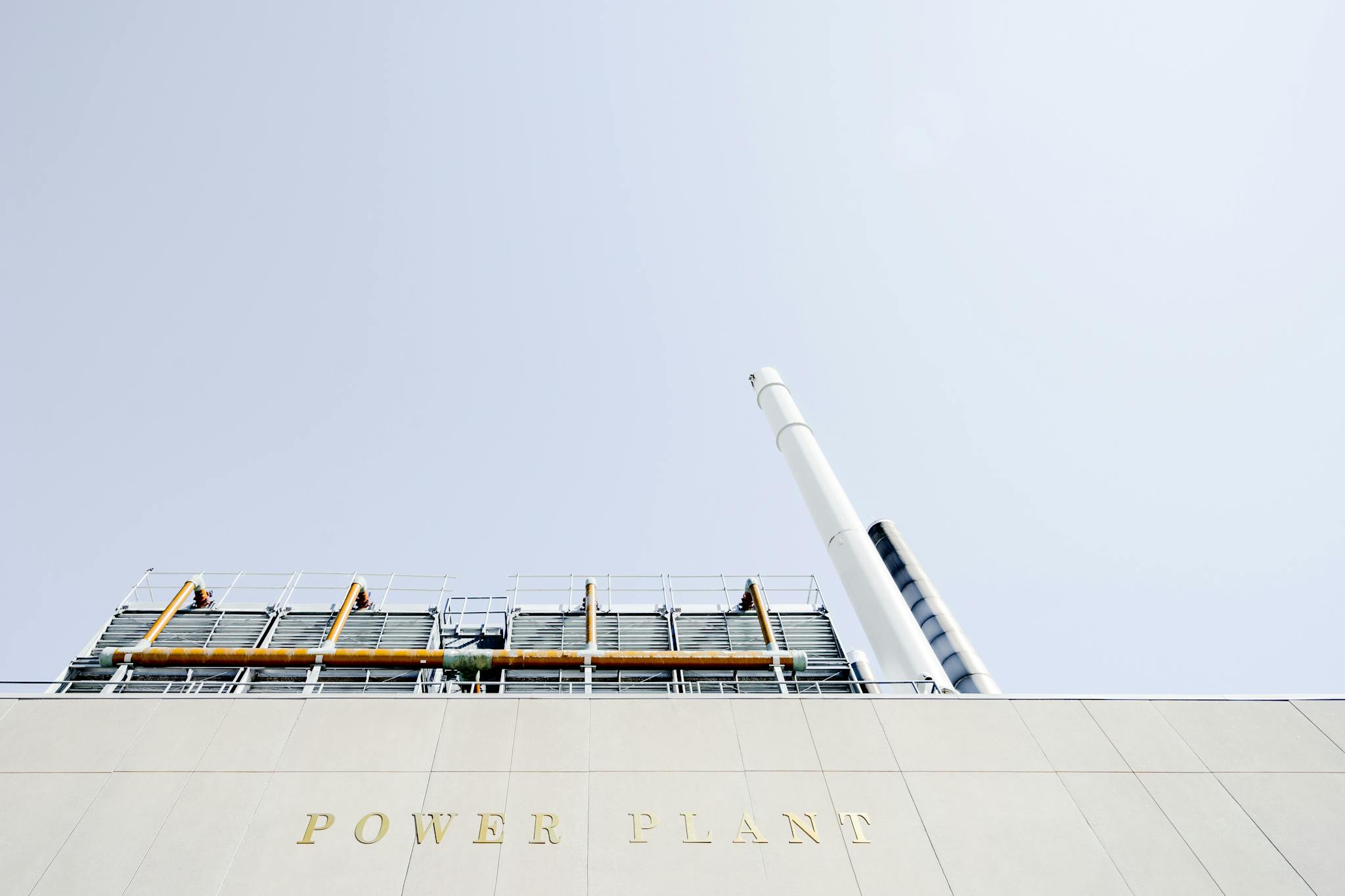 A modern power plant exterior with smokestacks under a clear sky in London, Ontario.